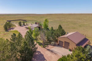 Aerial view of horse barn shop corrals and riding arena at Nebraska horse property for sale Kimball County