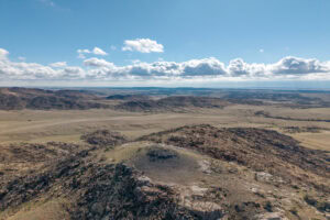 Rugged rock outcrop and upland views across the high plains on the northern end of Outpost Ranch, Wyoming