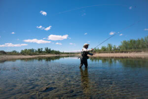 Angler fly fishing for trout in the North Platte River on Outpost Ranch near Guernsey, Wyoming